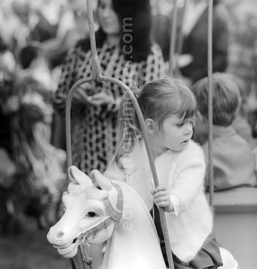 GDR image archive: Berlin - A little girl on a carousel horse in Berlin, the former capital of the GDR, the German Democratic Republic