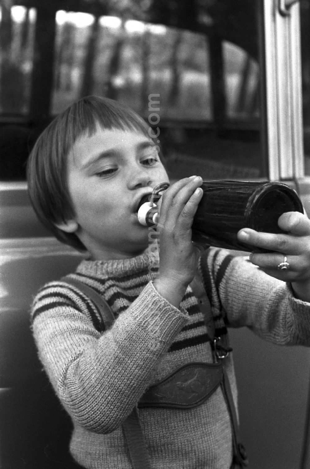 GDR photo archive: Malge - A girl drinking from a glass bottle of lemonade in Malge