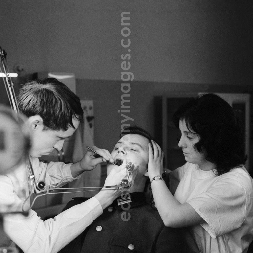 GDR picture archive: Strausberg - A soldier of the NVA with a treatment at the dentist in Strausberg in what is now the state of Brandenburg