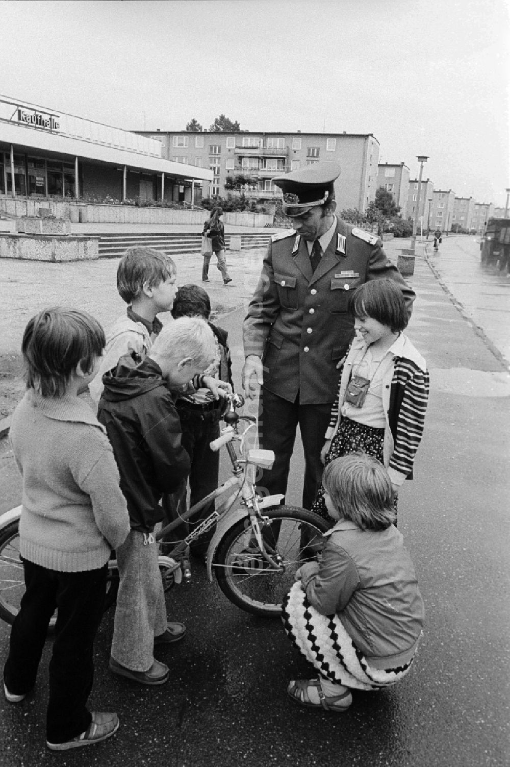 GDR picture archive: Berlin - A member of the People's Police / of segment authorised representative (ABV) with the road safety education in Berlin, the former capital of the GDR, German democratic republic. Here he controls the traffic suitability of a bicycle of the children