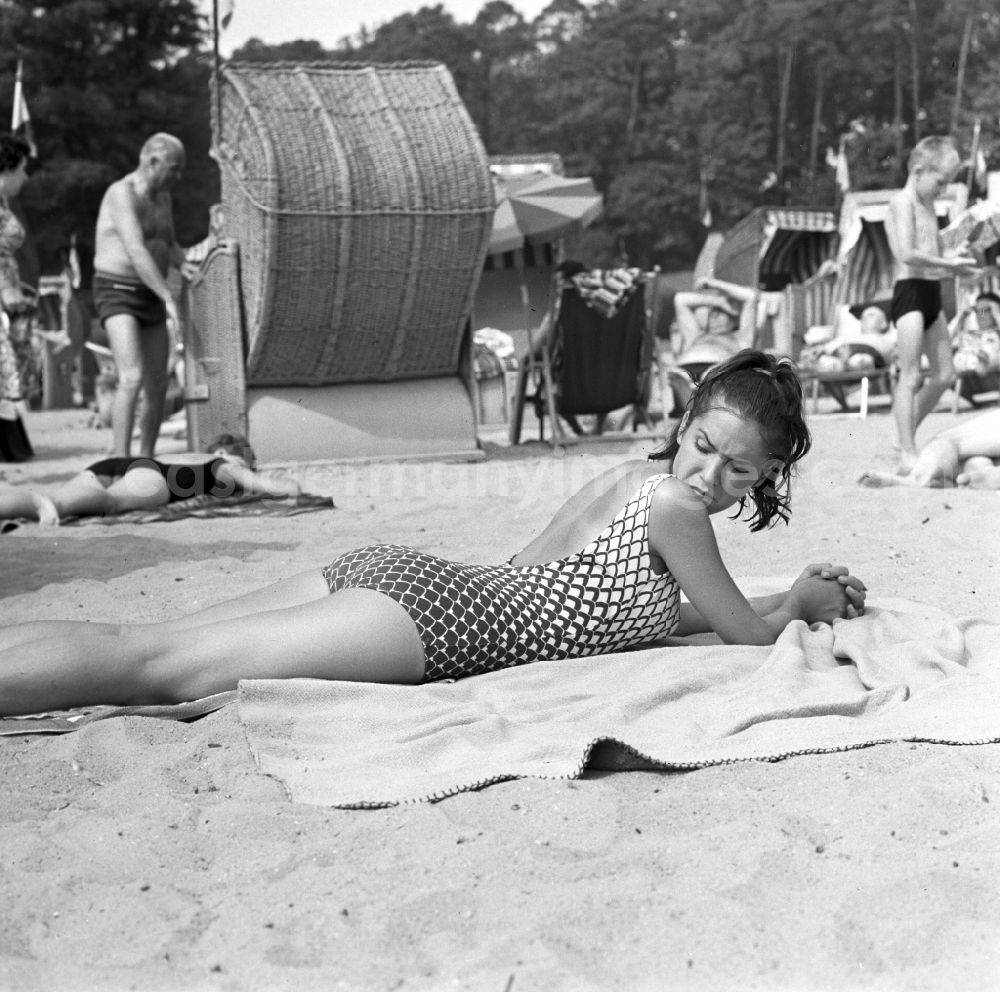 GDR picture archive: Berlin - Köpenick - A young woman lying on a towel in the beach Müggelsee in Berlin - Köpenick