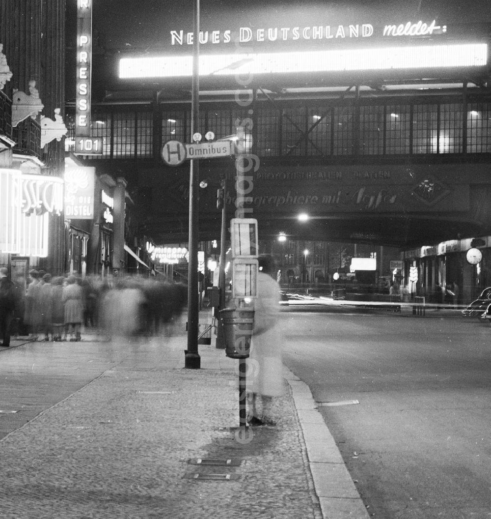 Berlin: A woman waits in the evening at a bus stop for a bus at Friedrichstrasse in Berlin, the former capital of the GDR, German Democratic Republic