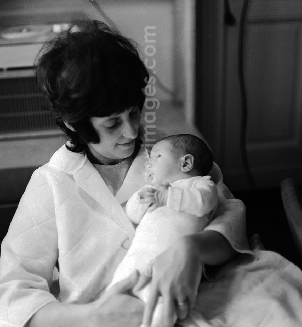 GDR photo archive: Berlin - A mother proudly holds her baby in her arms in Berlin