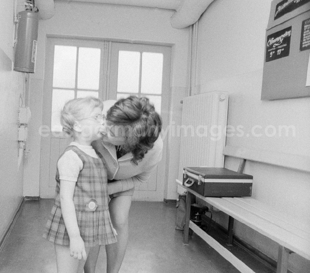 GDR photo archive: Eberswalde - A mother says goodbye to her child in kindergarten in Eberswalde in Brandenburg on the territory of the former GDR, German Democratic Republic