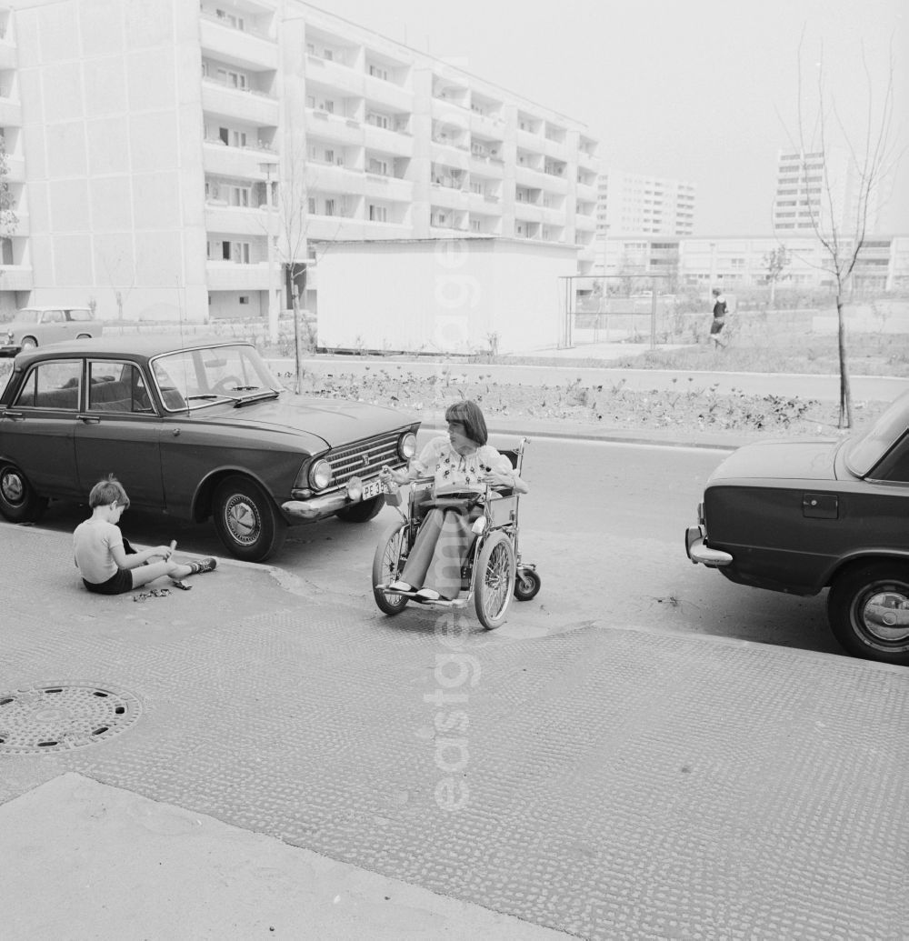 GDR photo archive: Berlin - A wheelchair user moves accessible on the street in Berlin-Marzahn