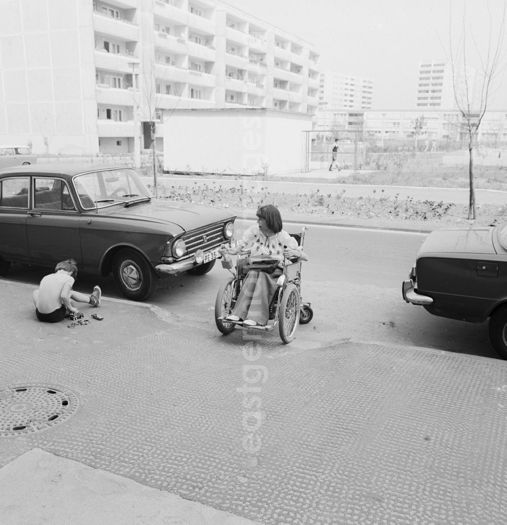 GDR picture archive: Berlin - A wheelchair user moves accessible on the street in Berlin-Marzahn