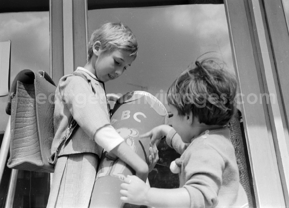 GDR photo archive: Berlin - A girl proudly holds her sugar bag on the day of school enrolment in Berlin, the former capital of the GDR, German Democratic Republic