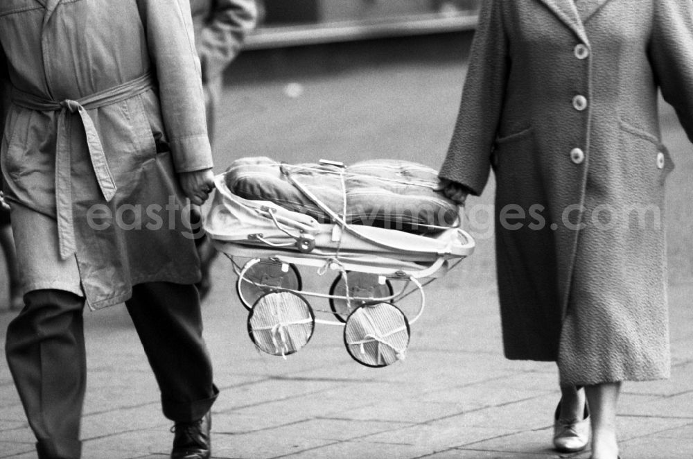 GDR photo archive: Berlin - Parents bought a stroller in East Berlin in the territory of the former GDR, German Democratic Republic