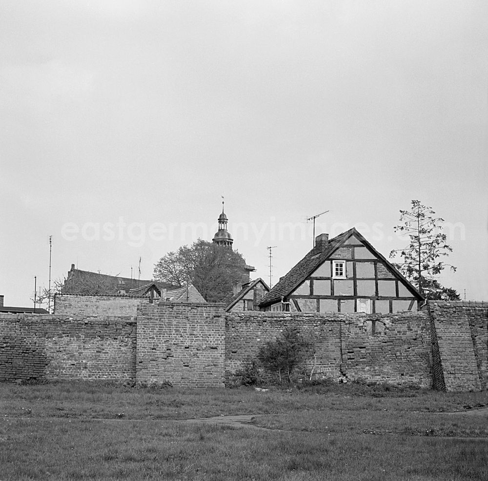 Wittstock/Dosse: City walls with half-timbered gable and church tower top in Wittstock/Dosse, Brandenburg in the area of ??the former GDR, German Democratic Republic