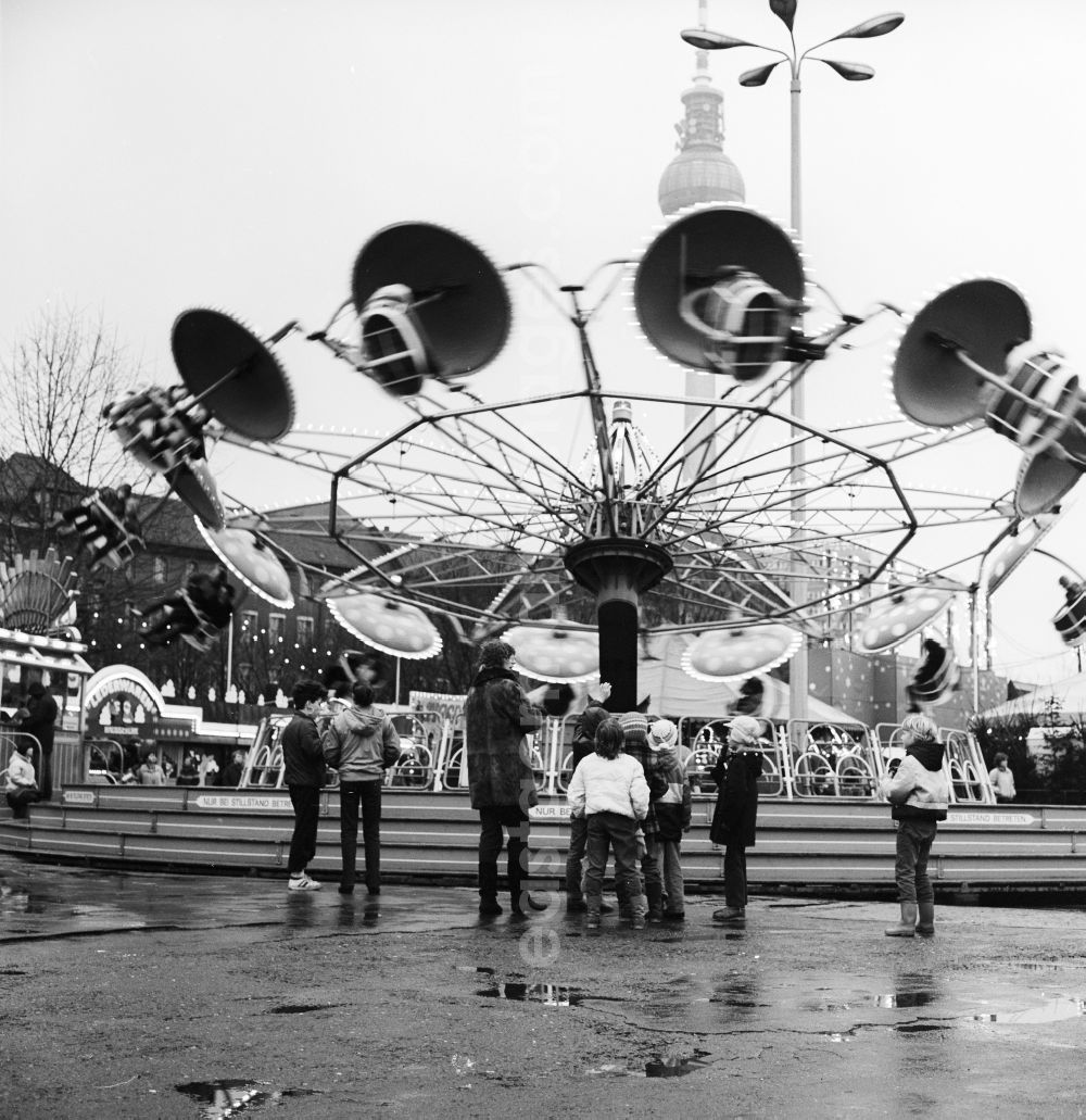 GDR photo archive: Berlin - Rides and visitors at the Christmas Market in Berlin, the former capital of the GDR, German Democratic Republic