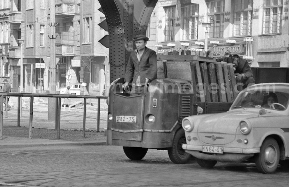 GDR picture archive: Berlin - Coal carrier soiled with dust while carrying heavy coal briquettes driving a Multicar M21 diesel ant in the district on street Schoenhauser Allee of Prenzlauer Berg in Berlin East Berlin on the territory of the former GDR, German Democratic Republic