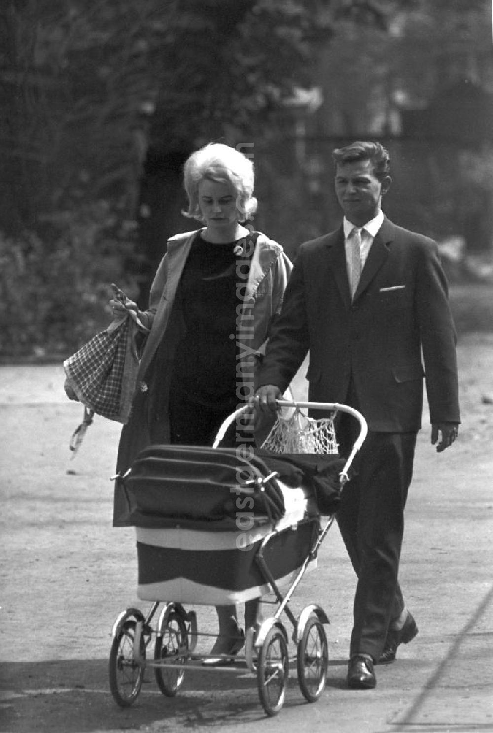 GDR image archive: Leipzig - Ein junges Paar geht mit seinem Baby im Kinderwagen in Leipzig spazieren.