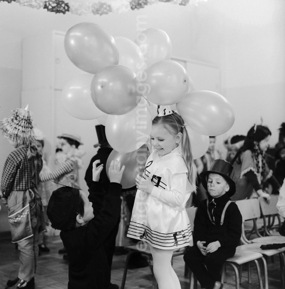 Berlin: Carnival in kindergarten in Berlin. Girl with balloons and dressed as a note