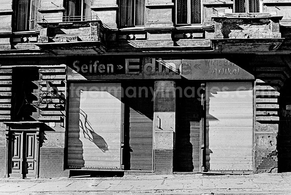 Berlin: Decaying plaster and masonry areas on the facadeof a former soap shop on the sidewalk of an old residential building in the district Prenzlauer Berg in Berlin Eastberlin on the territory of the former GDR, German Democratic Republic