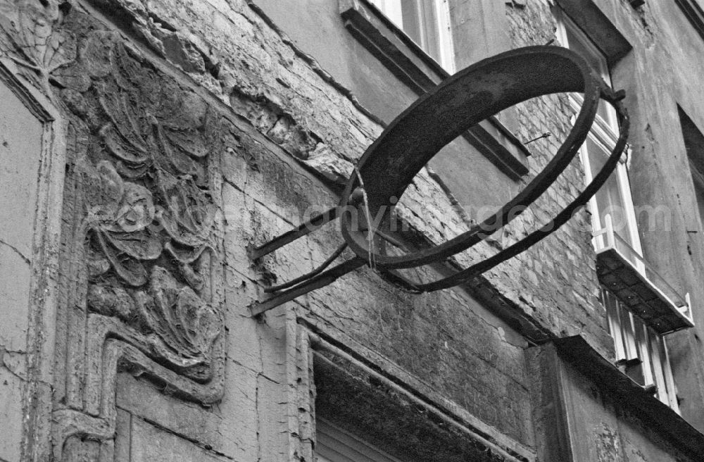 GDR photo archive: Berlin - Decaying plaster and masonry areas on the facadeat an Art Nouveau old building on street Schreinerstrasse in Berlin Eastberlin on the territory of the former GDR, German Democratic Republic