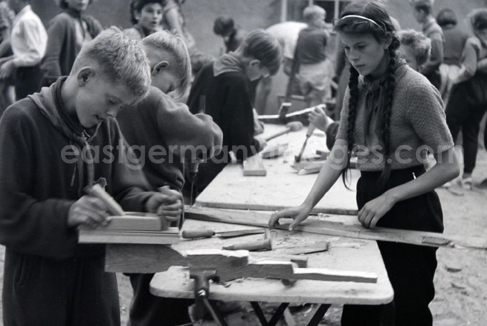 GDR photo archive: Prerow - Game with homemade wooden weapons by students and youths in the summer camp Kim Ir Sen of the pioneer organization Ernst Thaelmann in Prerow in the state Mecklenburg-Western Pomerania on the territory of the former GDR, German Democratic Republic