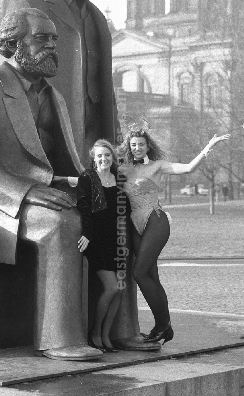 GDR photo archive: Berlin - As a young woman, Anja Kossak presents the latest women's fashion collection at a Playmate photo shoot in front of the statue of the Marx-Engels-Forum on Karl-Liebknecht-Strasse in the Mitte district of East Berlin in the area of the former GDR, German Democratic Republic