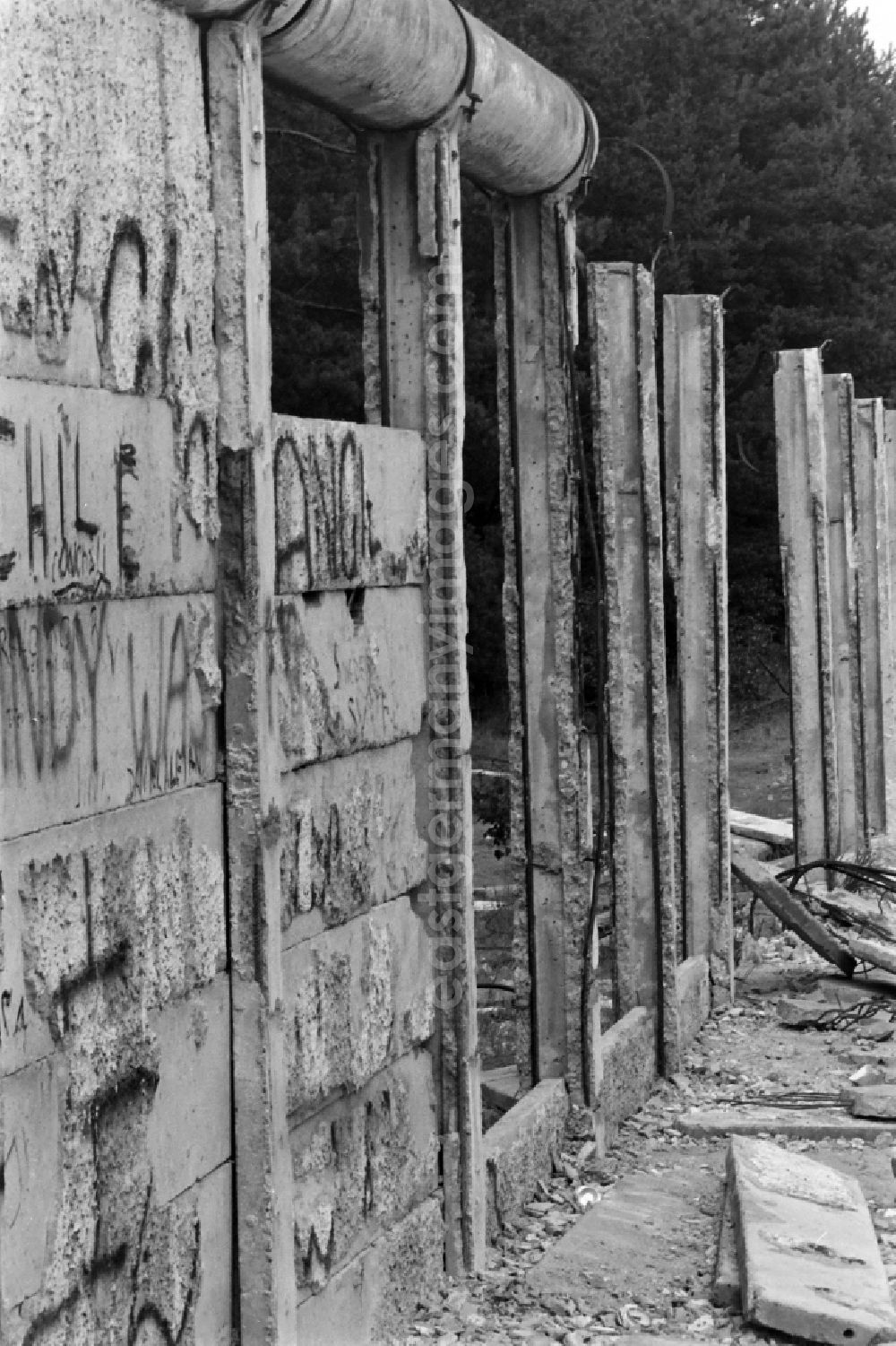 GDR picture archive: Berlin - Fragments of the decaying border fortifications and wall as well as security structures in the former border strip of the state border on a camp of the border troops in the district Steinstuecken in Berlin on the territory of the former GDR, German Democratic Republic