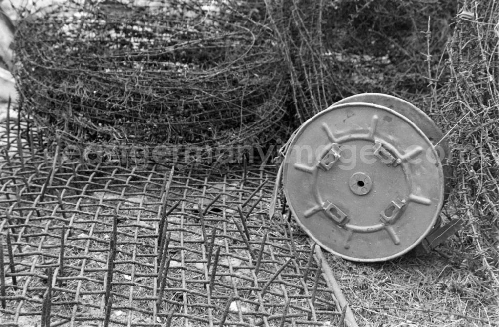 GDR photo archive: Berlin - Fragments of the decaying expanded metal barriers of the border fortifications and wall as well as security structures in the former border strip of the state border on a camp site of the border troops in the district of Steinstuecken in Berlin on the territory of the former GDR, German Democratic Republic
