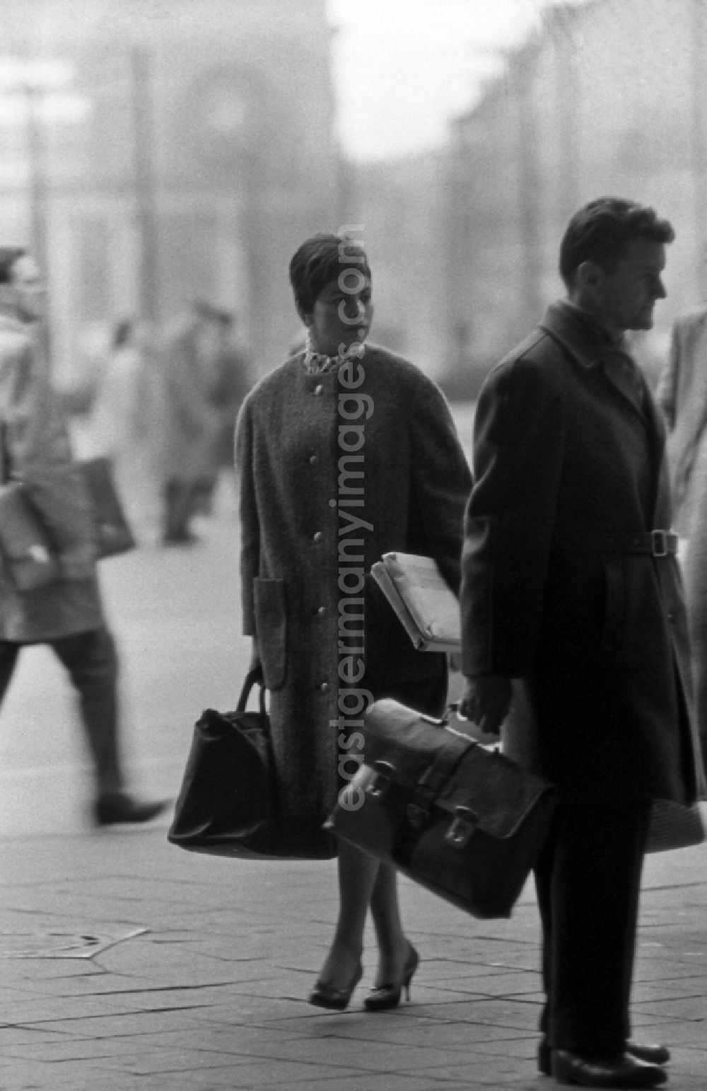 GDR picture archive: Berlin - Woman shopping through the city in East Berlin in the area of the former GDR, German Democratic Republic
