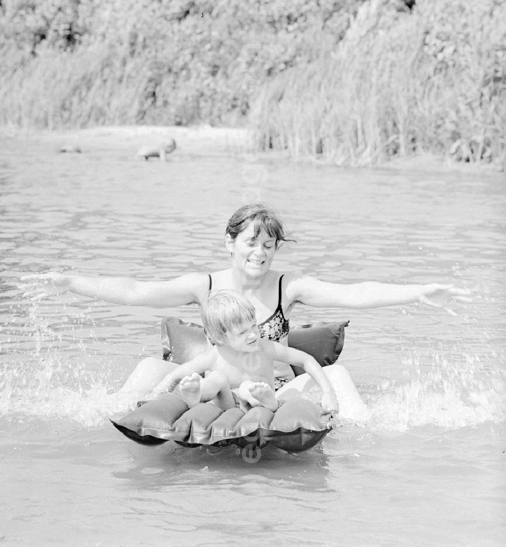 GDR photo archive: Teupitz - Woman with child on an air mattress on the Teupitzer lake in Teupitz in Brandenburg on the territory of the former GDR, German Democratic Republic