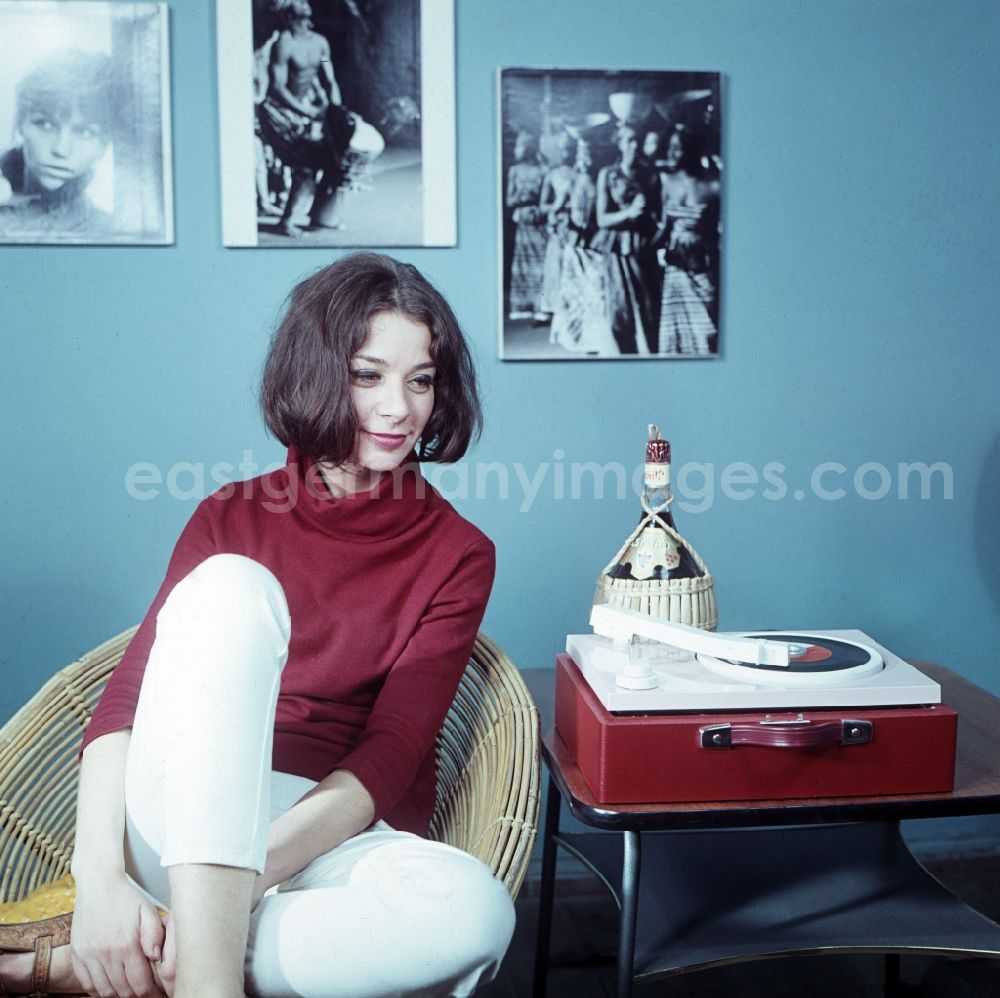 GDR image archive: Berlin - Young woman in front of a red portable record player from VEB RFT Phonotechnik Zittau and interior design of an apartment in the Pankow district of Berlin, the former capital of the GDR, German Democratic Republic