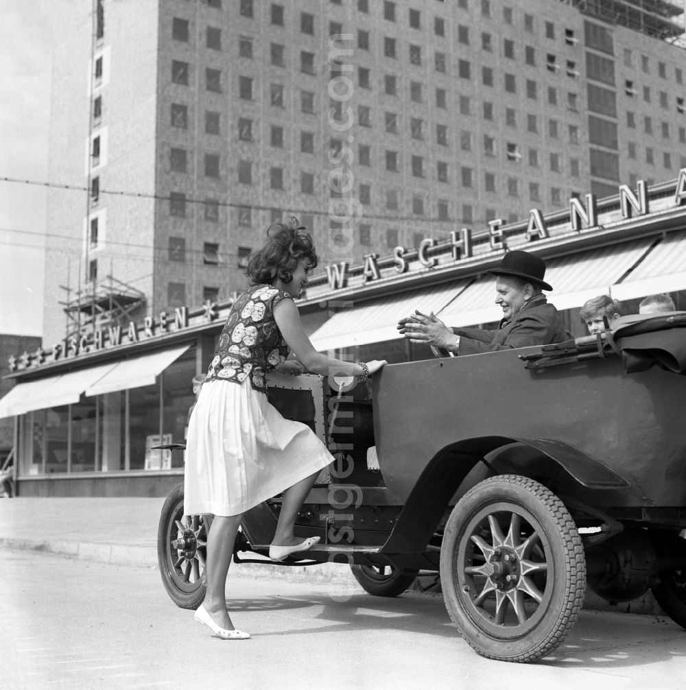 GDR image archive: Berlin - On Stalinallee, today Karl-Marx-Allee, a woman gets into a vintage F5 car from the automobile manufacturer MAF in Berlin on the territory of the former GDR, German Democratic Republic