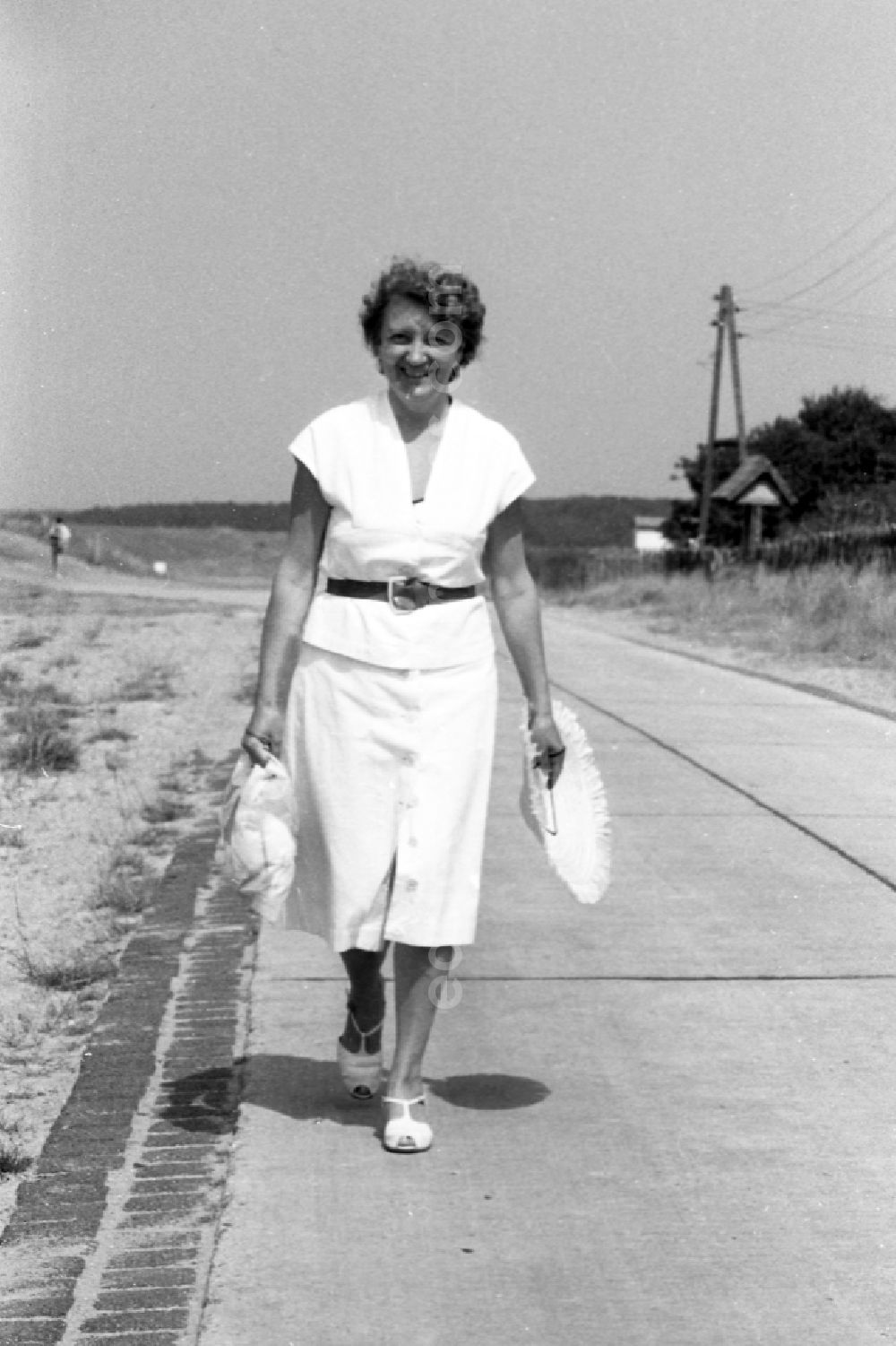 Bansin: A woman strolls on the seafront in Bansin in the federal state Mecklenburg-West Pomerania in the area of the former GDR, German democratic republic