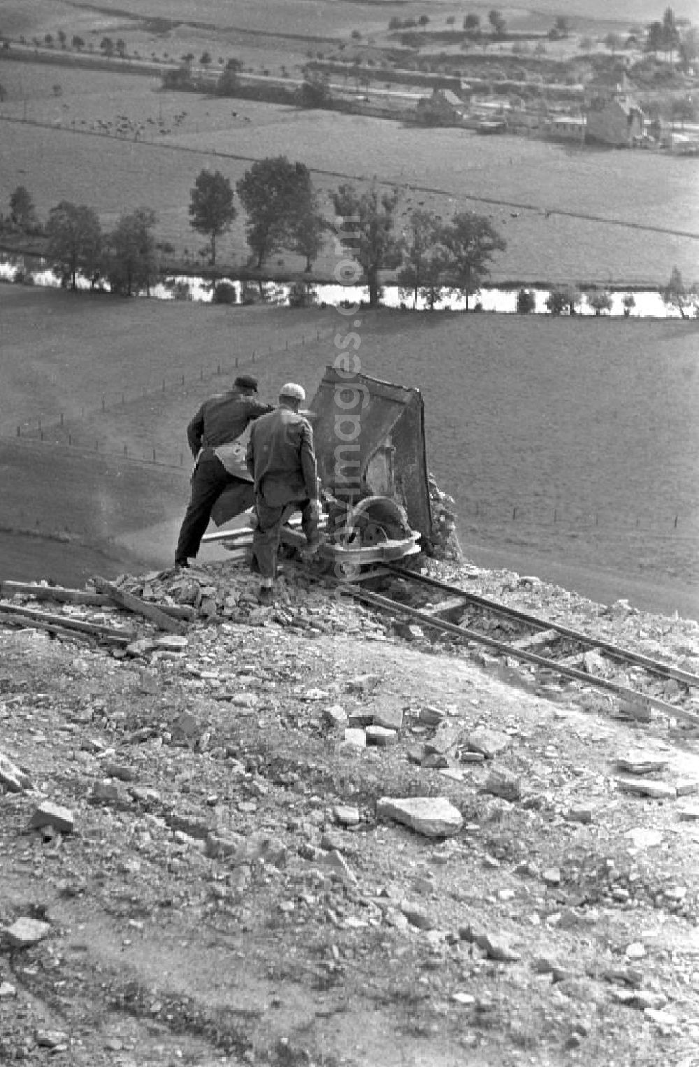 GDR picture archive: Freyburg - In mühsamer Handarbeit wird der Sand- und Kiesabbau im Tagebau östlich von Freyburg betrieben. Von hier aus werden die wichtigen Rohstoffe für den Bau von Häusern, Straßen und Betrieben an die Baulieferanten weitergeleitet.