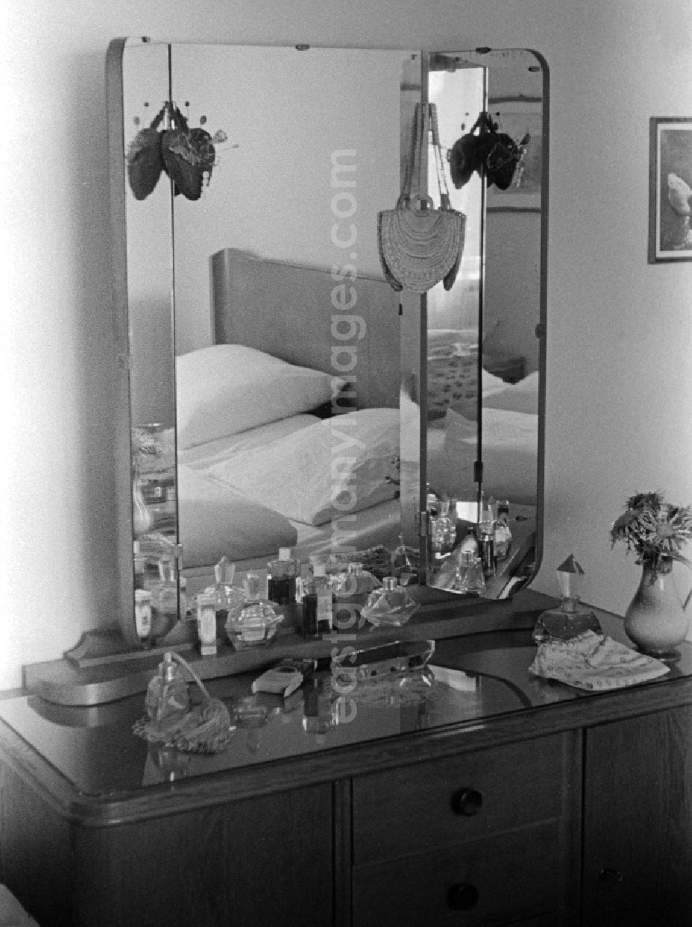 GDR photo archive: Halle (Saale) - A dressing table with 3-part mirror, glass top and different perfume bottles in a bedroom in hall (hall) in the federal state Saxony-Anhalt in the area of the former GDR, German democratic republic