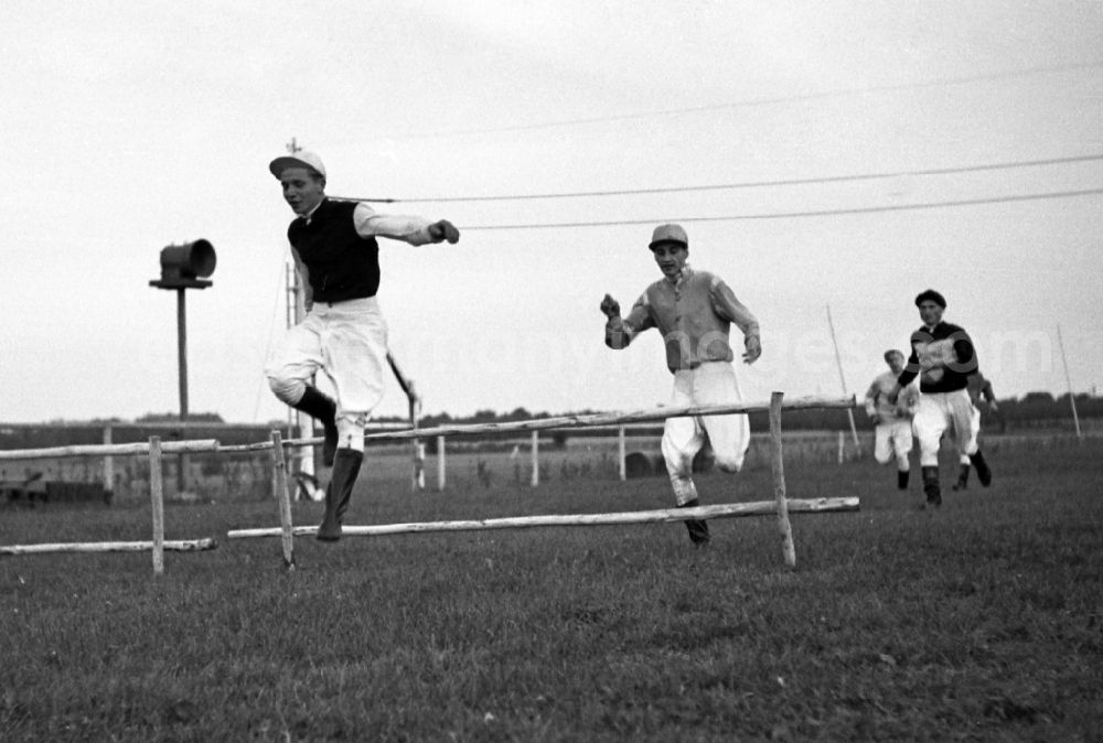 GDR picture archive: Dresden - Jockeys jump over a hurdle without horses at Dresden-Seidnitz racecourse in the state Saxony on the territory of the former GDR, German Democratic Republic