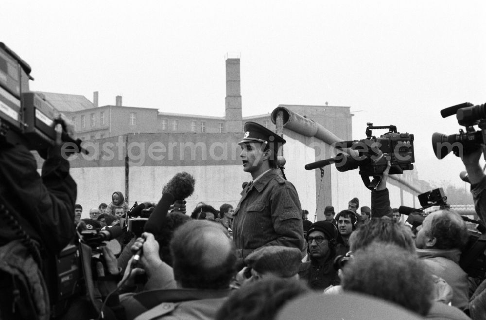 GDR image archive: Berlin - Border soldier speaks to everyone during the opening of the border at Potsdamer Platz in the district Mitte in Berlin, the former capital of the GDR, German Democratic Republic
