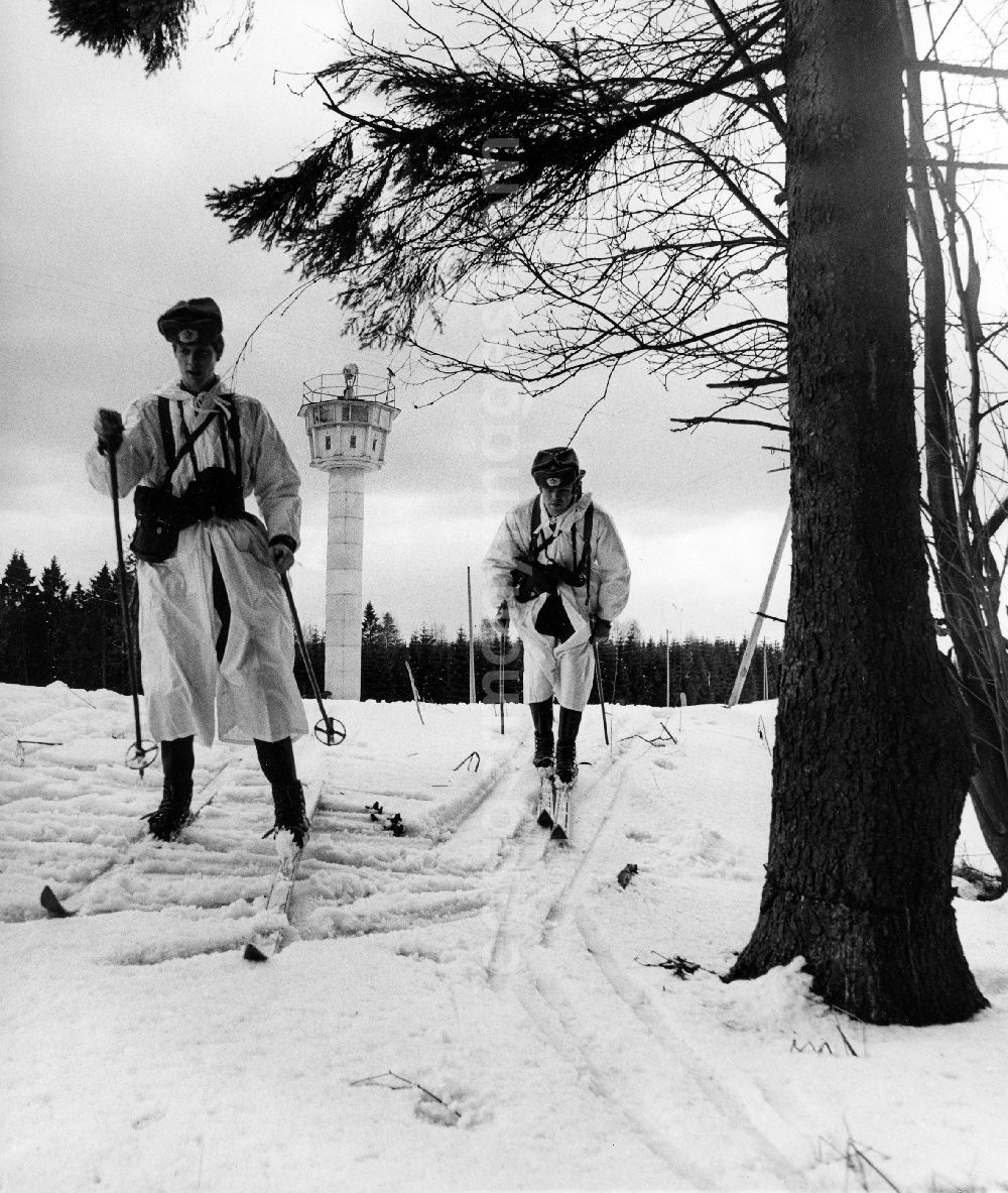 GDR image archive: Abbenrode - Border Patrol in snow in the winter with dog, car and motorcycle near Abbenrode in today's federal state of Saxony-Anhalt. The border guards are equipped with AK-47 machine guns