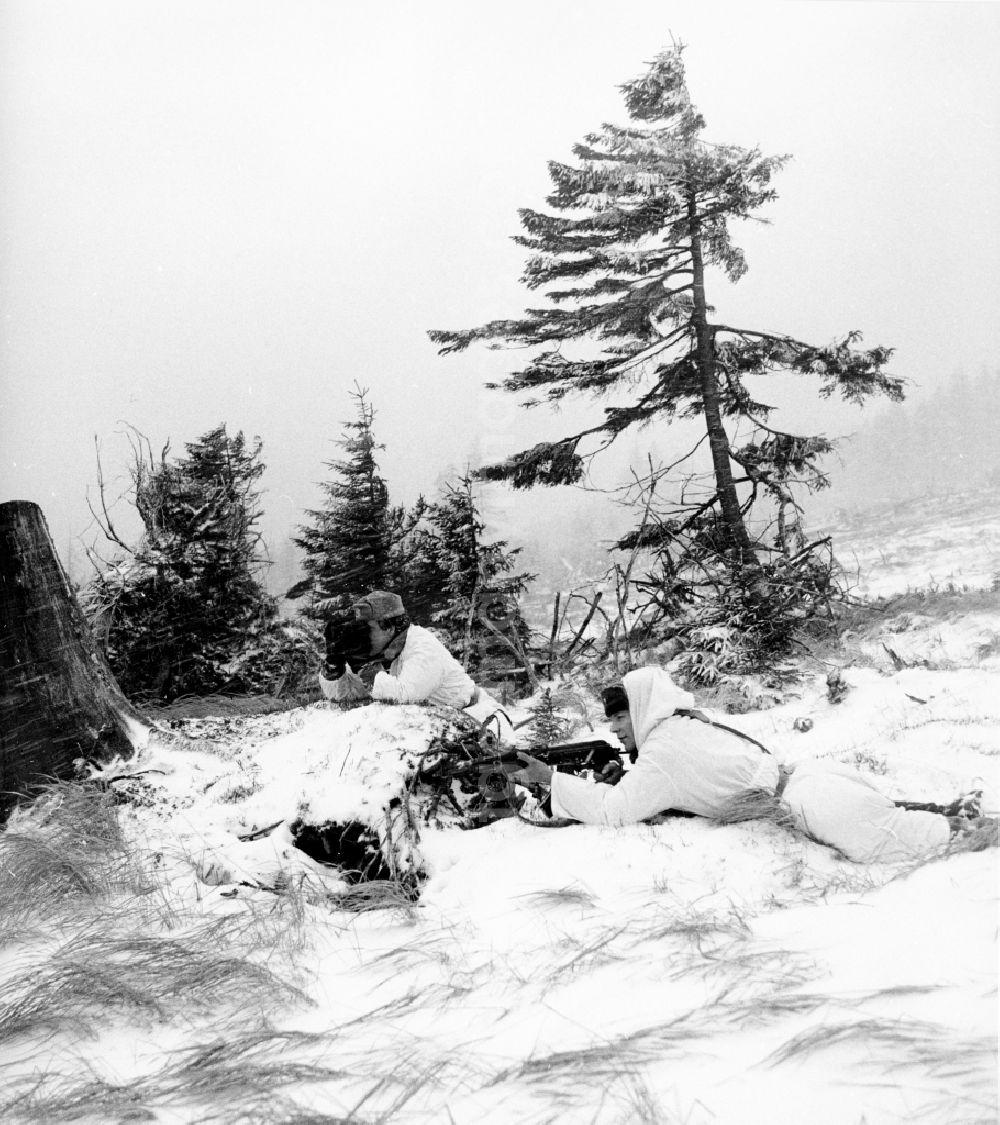 GDR image archive: Abbenrode - Border Patrol in snow in the winter with dog, car and motorcycle near Abbenrode in today's federal state of Saxony-Anhalt. The border guards are equipped with AK-47 machine guns