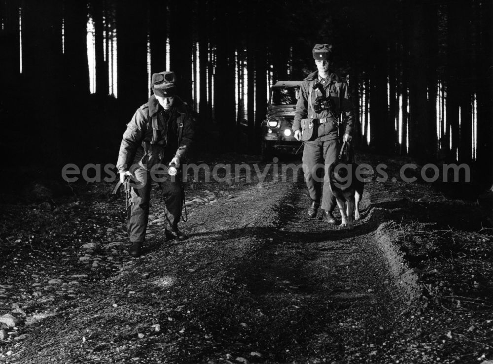 GDR picture archive: Abbenrode - Border Patrol with dog, car and motorcycle near Abbenrode in today's federal state of Saxony-Anhalt. The border guards are equipped with AK-47 machine guns