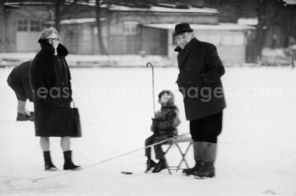 Berlin: Grandparents with their grandson ice-fishing on a lake in Berlin, the former capital of the GDR, German Democratic Republic