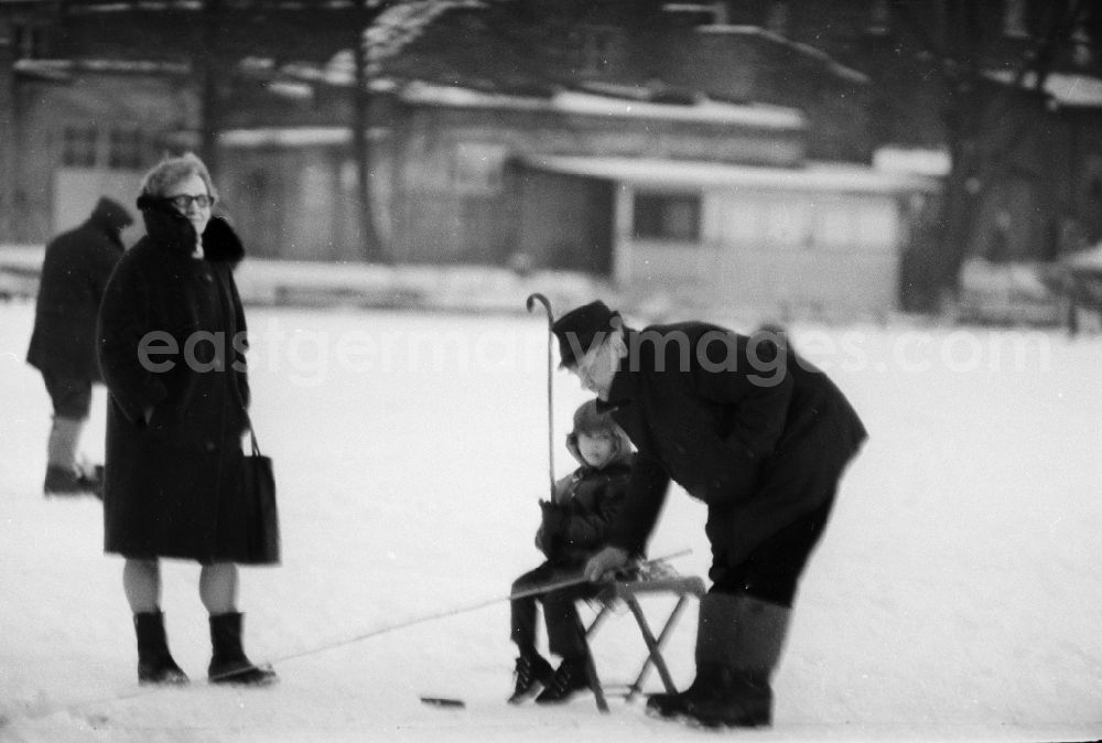 GDR image archive: Berlin - Grandparents with their grandson ice-fishing on a lake in Berlin, the former capital of the GDR, German Democratic Republic