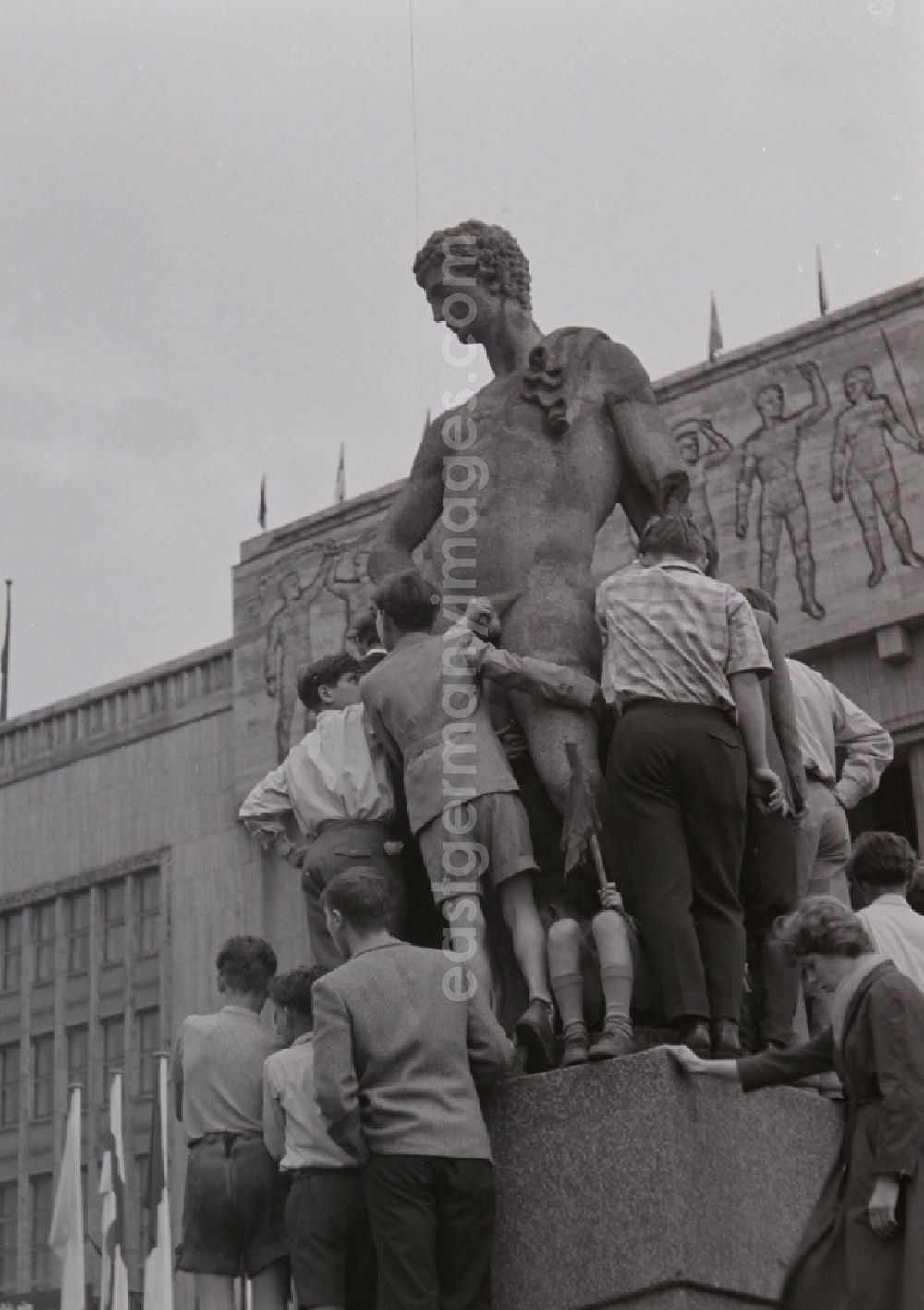 GDR image archive: Berlin - Fun and games for children and teenagers in front of a stone sculpture in front of the Deutsche Sporthalle on Stalinallee - today's Karl-Marx-Allee in the district Friedrichshain in Berlin, the former capital of the GDR, German Democratic Republic