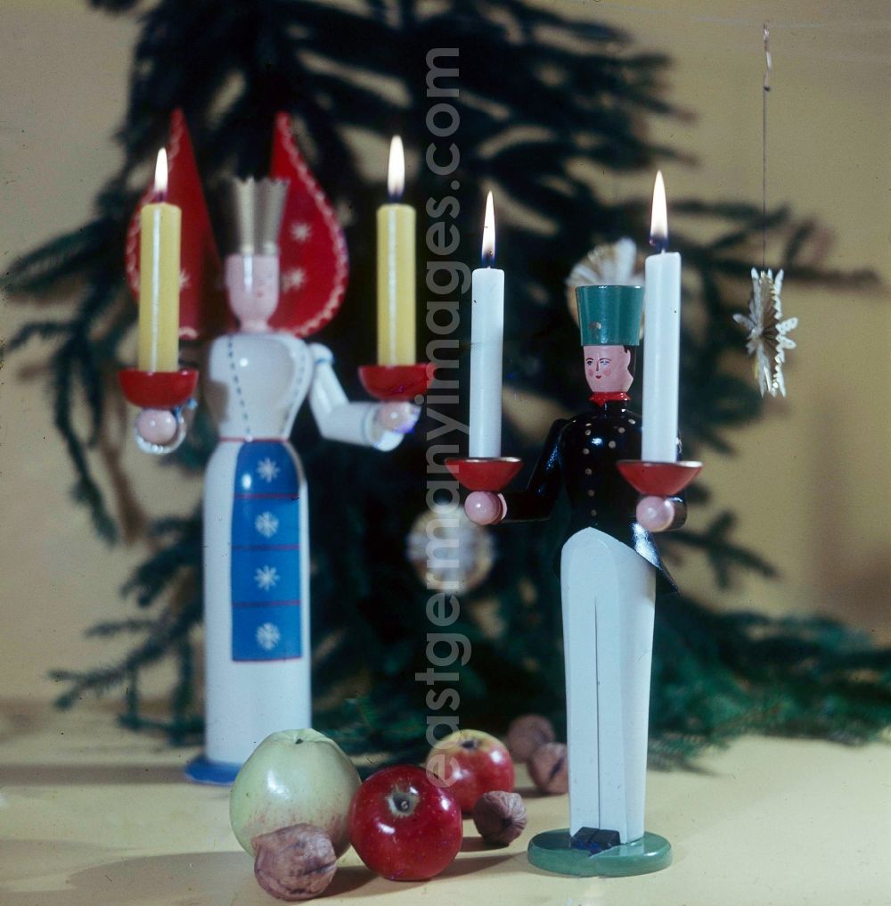 GDR picture archive: Annaberg-Buchholz - Stilted Christmassy craft art from the Erzgebirge in Anna's mountain book wood in the federal state Saxony in the area of the former GDR, German democratic republic. Here a miner and an angel with candles