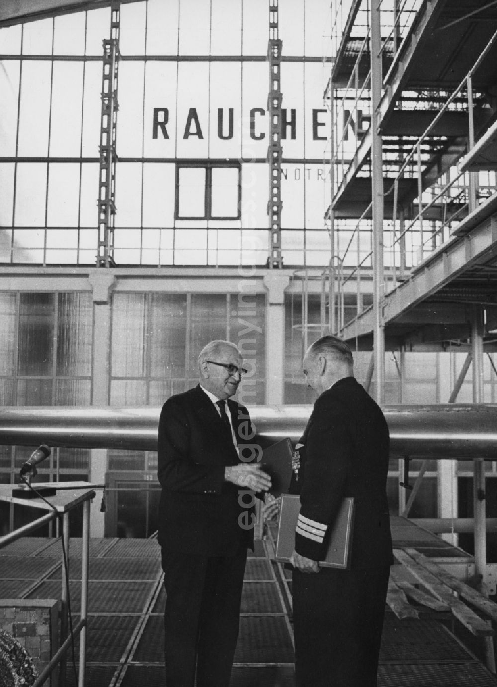 GDR picture archive: Schönefeld - The Principal Director of Deutsche Lufthansa Arthur Pieck in conversation with the Minister of Transport Dr. Erwin Kramer in a hangar at Schoenefeld in what is now the state of Brandenburg