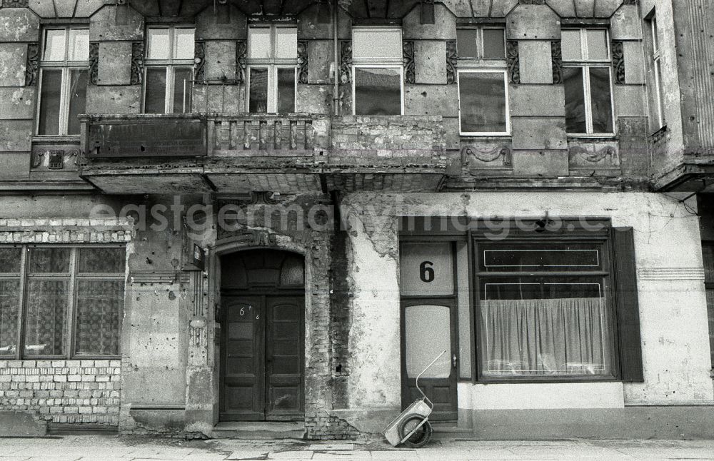 GDR image archive: Berlin - House entrance and facade of the building front of a dilapidated old building facade on street Danziger Strasse in the district Pankow in Berlin Eastberlin on the territory of the former GDR, German Democratic Republic
