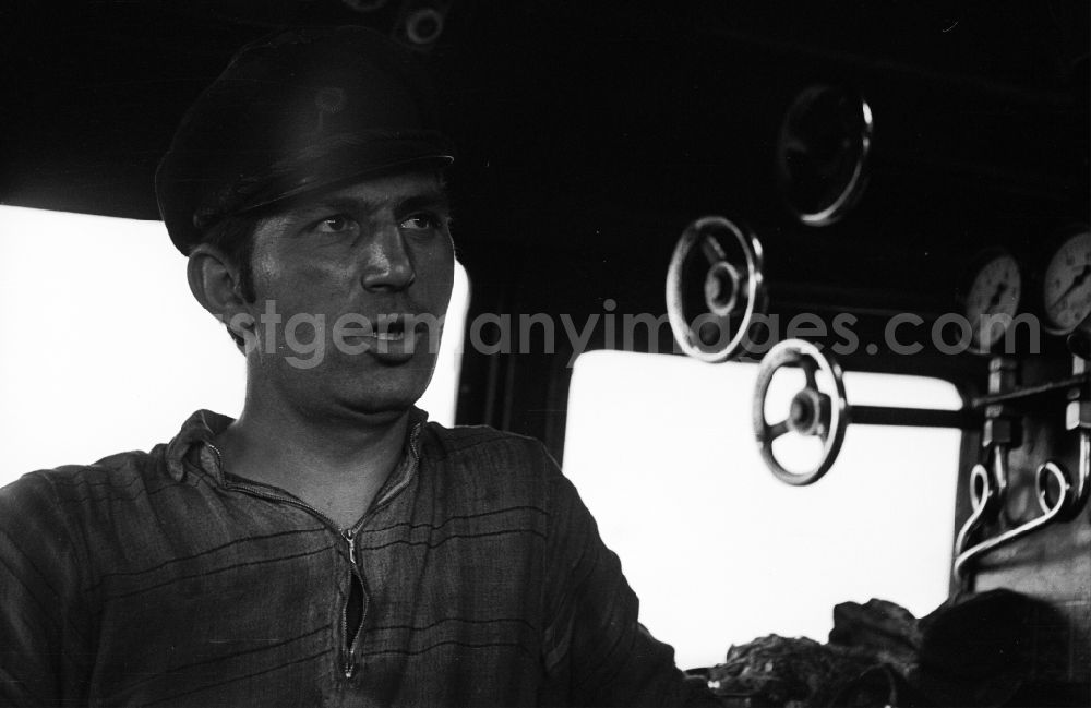 GDR picture archive: Halberstadt - Portrait shot a stoker in the driver's cab of a class steam locomotive 41 1116 in Halberstadt in the state Saxony-Anhalt on the territory of the former GDR, German Democratic Republic