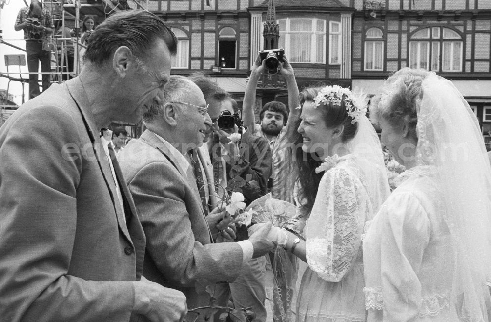 GDR image archive: Wernigerode - Kurt Hager, member of the Central Committee (ZK) and Political Bureau of the CC of the Socialist Unity Party of Germany (SED), and Werner Eberlein, member of the Politburo of the Central Committee of the SED, 1st secretary of the SED district administration Magdeburg, congratulate a bride on the marketplace after the wedding in Wernigerode in the state Saxony-Anhalt on the territory of the former GDR, German Democratic Republic
