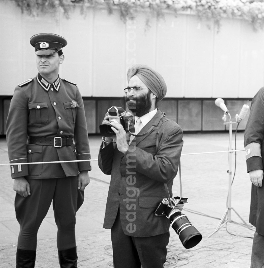 GDR picture archive: Berlin Mitte - Indian media representatives - Photographer at a GDR- soldier in front of the grandstand at 1 May, Schlossplatz in Berlin - Mitte