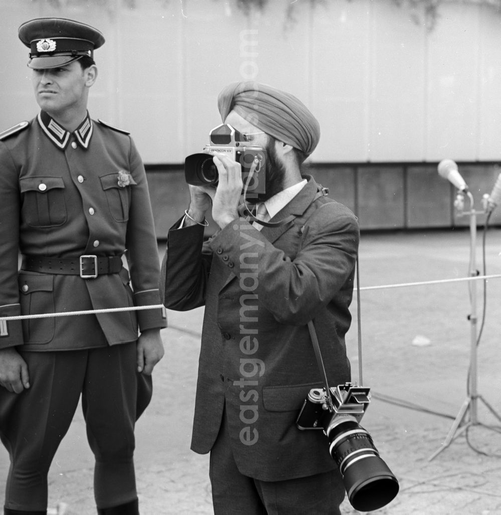 Berlin Mitte: Indian media representatives - Photographer at a GDR- soldier in front of the grandstand at 1 May, Schlossplatz in Berlin - Mitte