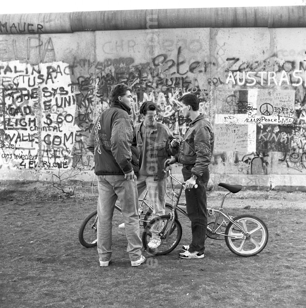 Berlin: Adolescents with BMX bikes at the Berlin Wall