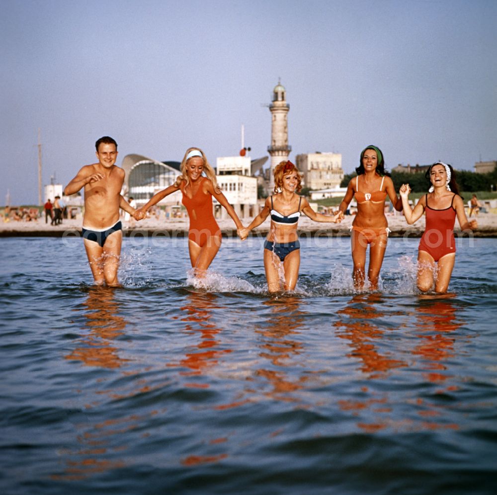 GDR picture archive: Rostock - Young people present the latest summer swimwear on the Baltic Sea beach in the district Warnemuende in Rostock in the state Mecklenburg-Western Pomerania on the territory of the former GDR, German Democratic Republic