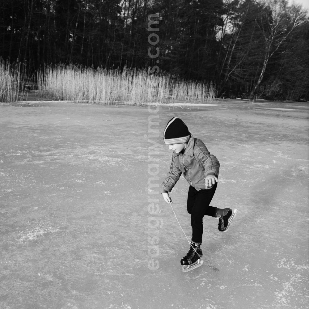 GDR photo archive: Grünheide (Mark) - Boy skating on a frozen lake in Green Heath (Mark) in today's Brandenburg