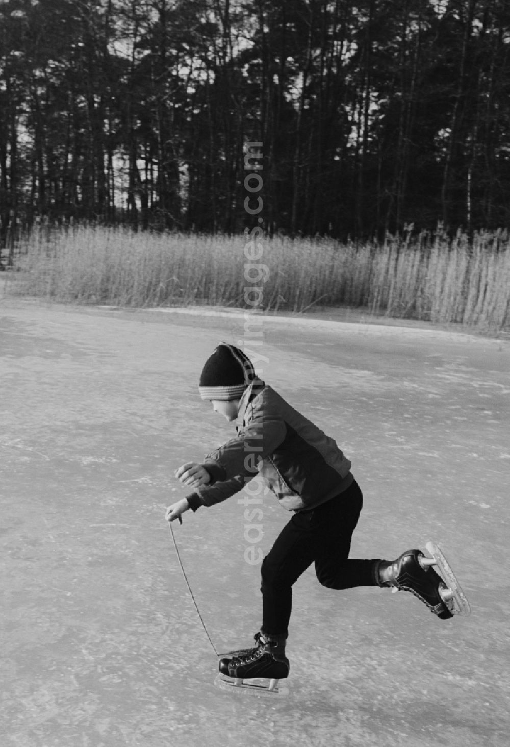 GDR picture archive: Grünheide (Mark) - Boy skating on a frozen lake in Green Heath (Mark) in today's Brandenburg