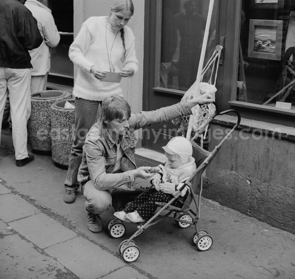 GDR picture archive: Zittau - Young Family with a stroller in Zittau in the state Saxony on the territory of the former GDR, German Democratic Republic